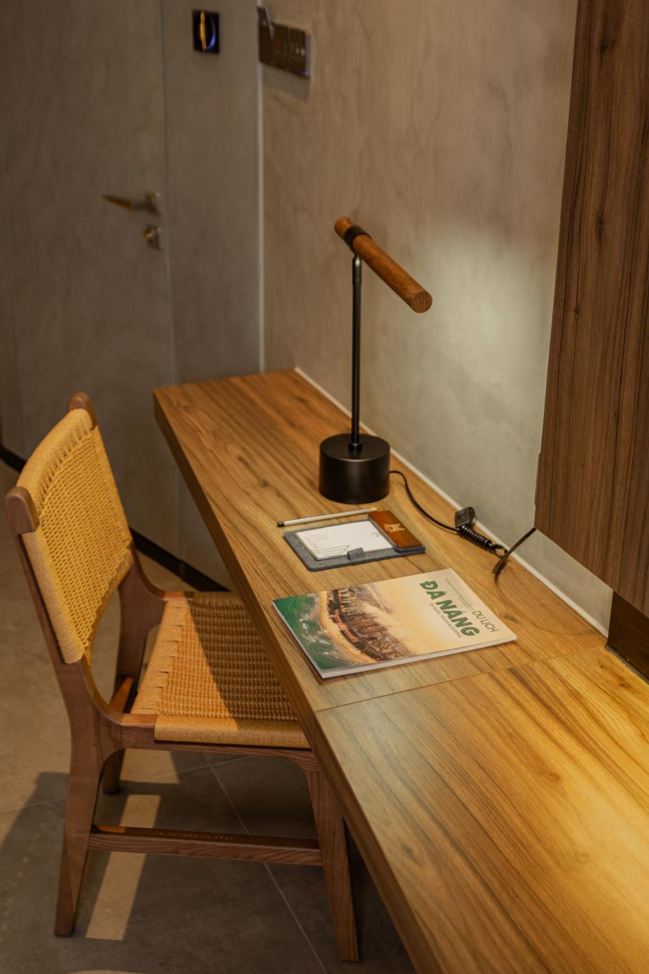 M Hotel Danang Εξωτερικό φωτογραφία A desk with a magazine on it